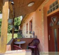A family house in Medzev with a wooden terrace and ornamental garden, peaceful atmosphere.