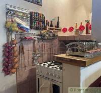 Traditional kitchen in a family house with spices, onions, and kitchenware.