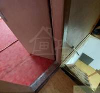 A staircase leading to a room with a red carpet and boxes in a cabin.
