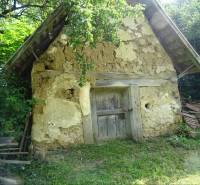 An old shed made of clay and wood in the garden of a family house in Tornaszentandrás.