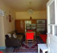 Living room in a family house with retro furniture and decorations on the walls.