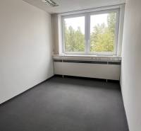 Offices with white walls and a large window.
