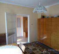 Interior in a family house with a wooden wardrobe and a connecting hallway.