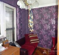Purple room with patterned walls and furniture in a family house.