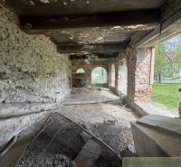 The interior of an unfinished family house with raw walls and a view outside.