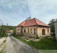 A family house in Rimavská Sobota with a red roof and a large yard.