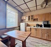 A kitchen in a family house with wooden furniture and appliances.