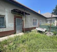 A family house in Nové Zámky with a plastered facade and a neglected yard.