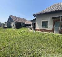 A family house in Nové Zámky with an older rural style surrounded by a grassy plot.