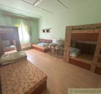 Bedroom with bunk beds and furniture in a family house, light green wall.