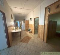 Hallway with wooden paneling and a table in a family house.