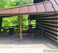 Wooden cottage near Kežmarok with a covered gazebo and green surroundings.