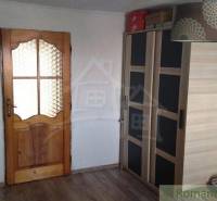 Interior of a family house with a wardrobe and wooden doors.