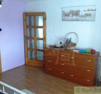 A bedroom in a family house with a wardrobe, a dresser, and a painting of elephants.