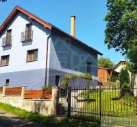 A family house in Spišská Nová Ves with a garden and fencing on a quiet street.