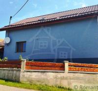 A family house in Spišská Nová Ves with a satellite dish and a wooden fence.