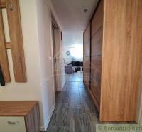 A hallway with wooden furniture and tiles in a family house.