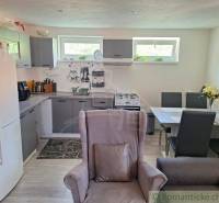 A kitchen in a family house with furniture, a sofa, and a dining table.