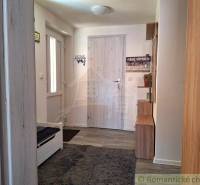 Entrance hallway with carpet and wooden furniture in a family house.