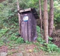 A wooden hut in the middle of the forest near Ružomberok, next to a family house.