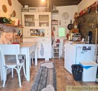 A rustic kitchen in a family house with wooden furniture and decorations on the walls.