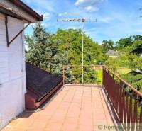 The balcony of a family house in Plavecký Štvrtok with a view of the trees and an antenna.