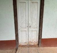 Old wooden door and tiles in a cottage in Nové Zámky.