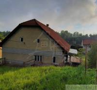 A family house in Žiar nad Hronom with a sloped roof and green surroundings.