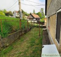 A family house in Žiar nad Hronom with a small yard and a metal fence, view of the houses.