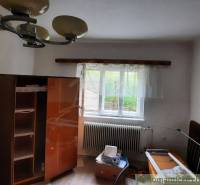 A room in a family house with simple furniture and a window, a bright space.