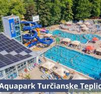 Aquapark Turčianske Teplice with pools, water slides, and relaxation facilities amidst nature.