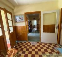 Family house with tiled hallway and glass doors, wall decoration.