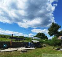 Countryside scenery at the cottage in Veľký Krtíš with clouds and greenery.