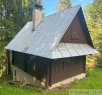 A wooden cottage in Kokava nad Rimavicou, surrounded by forests and greenery.