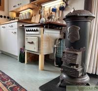 Kitchen in a cottage with an old stove and rustic elements.