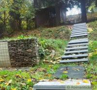 A cottage in Bratislava - Lamač, stairs leading through a green slope, natural surroundings.