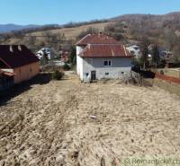 A family house in Nová Sedlica with a garden and hilly landscape in the background.