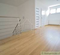 Open space with a staircase and wooden flooring in a family house.