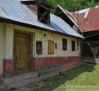 Old family house in Hačava with a tin roof and wooden doors.