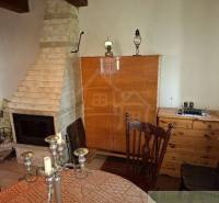 The fireplace and wooden furniture in the cabin create a cozy atmosphere.