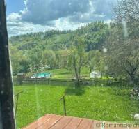 The garden of a family house in Kokava nad Rimavicou with a swimming pool and green landscape.