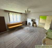 A living room in a family house with wooden flooring and vintage furniture.