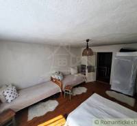 The interior of a family house with beds and a lamp offers a cozy atmosphere.