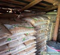 A pellet storage room in a family house with wood and a bucket.