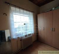 A room with a wardrobe, a mirror, and a window, located in a family house.