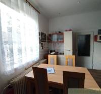 Dining room in a family house, furniture, curtains, window, country style, interior.