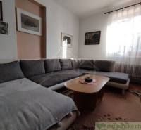 Living room with a comfortable couch and a wooden table in a family house.