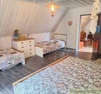 A room in a family house with a wooden floor, nicely furnished, comfortable beds.