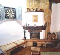 The fireplace and the chessboard are located in a cozy family house, creating a warm atmosphere.