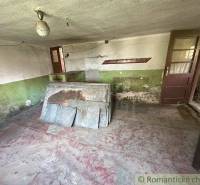 An older room needs renovation, with plaster and flooring requiring repairs in a family house.